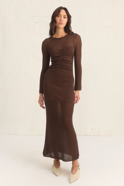 Mon Renn Onika Knit Dress in mahogany. A fitted long-sleeve dress in a viscose blend with ruching at the front, sheer contrast panels, and full body lining.
