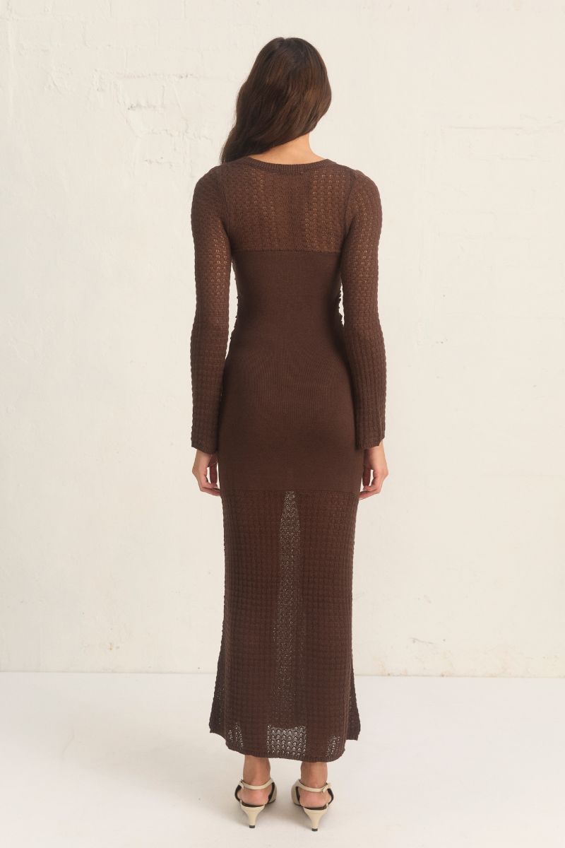 Mon Renn Onika Knit Dress in mahogany. A fitted long-sleeve dress in a viscose blend with ruching at the front, sheer contrast panels, and full body lining.
