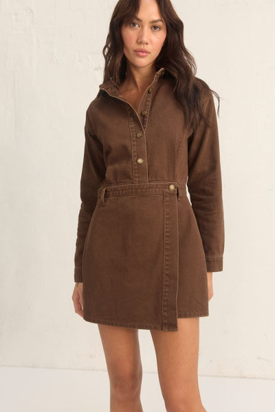 Model wearing the Mon Renn Bayside Denim Dress in coffee — a structured long sleeve mini dress with a button front and wrap skirt.