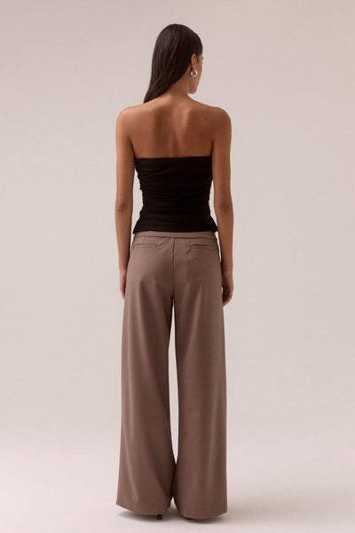 SOVERE STUDIO MYRIAD black ruched strapless top Model front-facing in black strapless top with hands relaxed