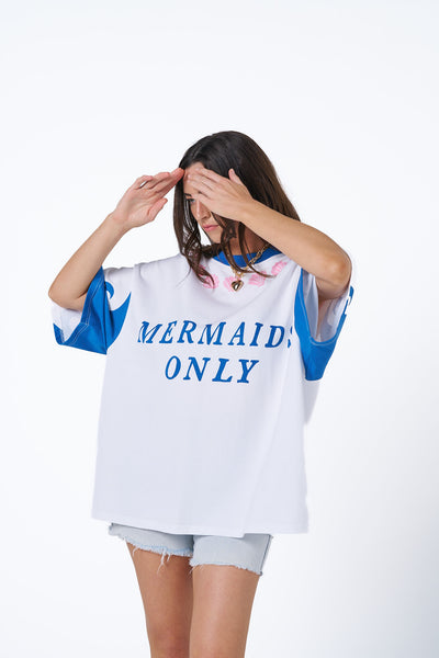 Oversized Hibiscus Hotel Mermaids Only Lounge Tee in white with bold blue graphics, styled for poolside.