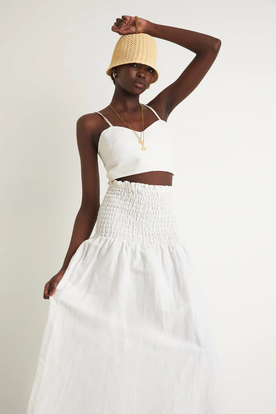 ZERAFIMA The Island Bodice Crop is a cropped and fitted corset top featuring in classic white linen blend. Wear it with Island Paper bag Pant for the complete resort outfit.White Tops